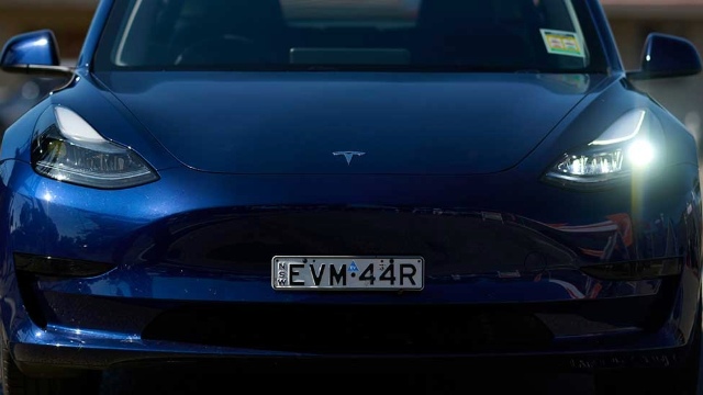 A dark blue Tesla