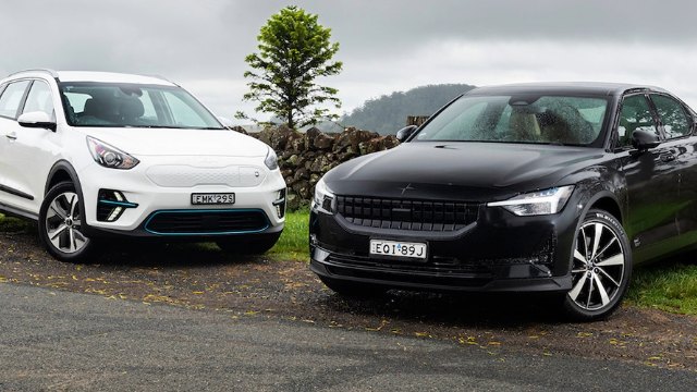 An EV and a hybrid vehicle sit parked beside each other 