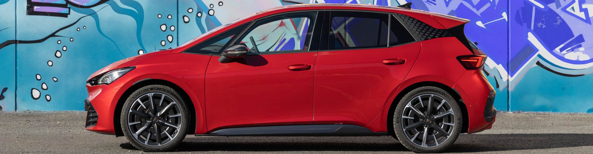 2024 Cupra Born in a front of a graffiti wall