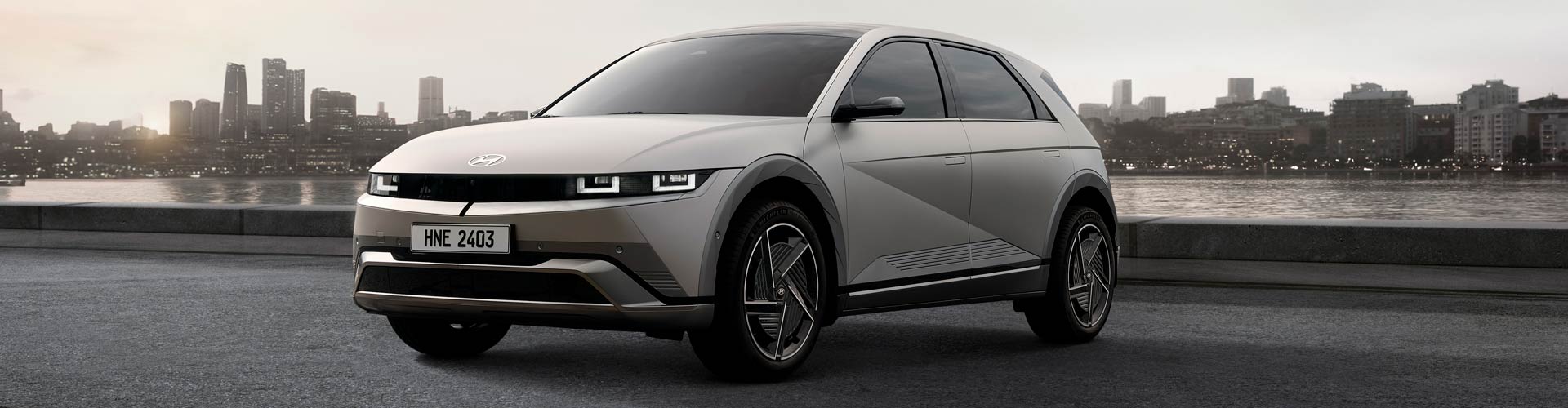 Silver Hyundai Ioniq parked in front of harbour