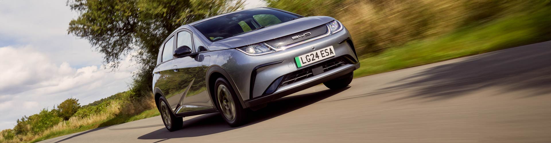 BYD Dolphin hatchback driving on country road