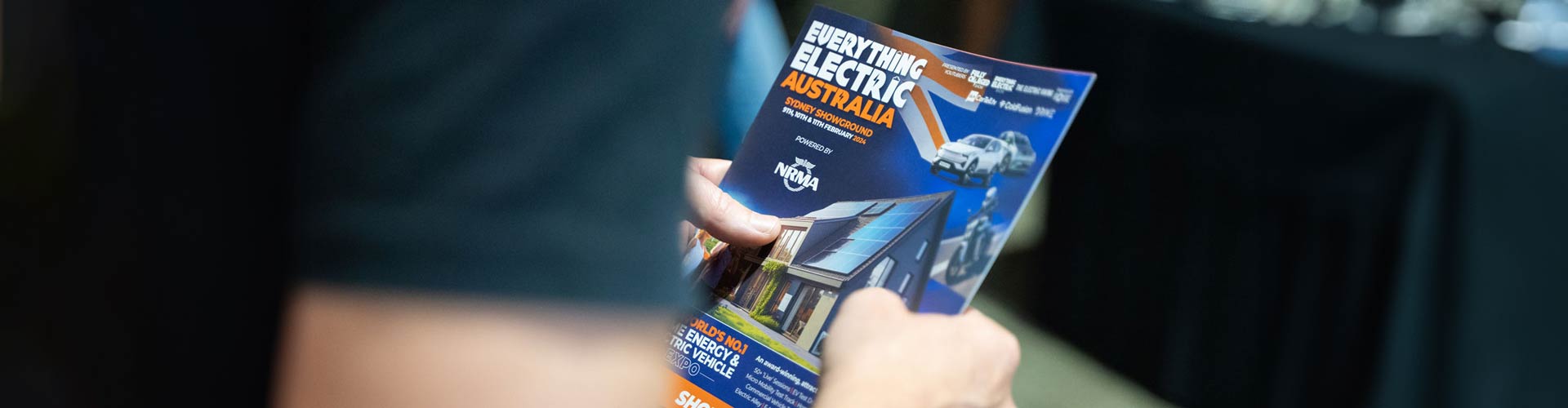 Person holding a brochure with blurred foreground