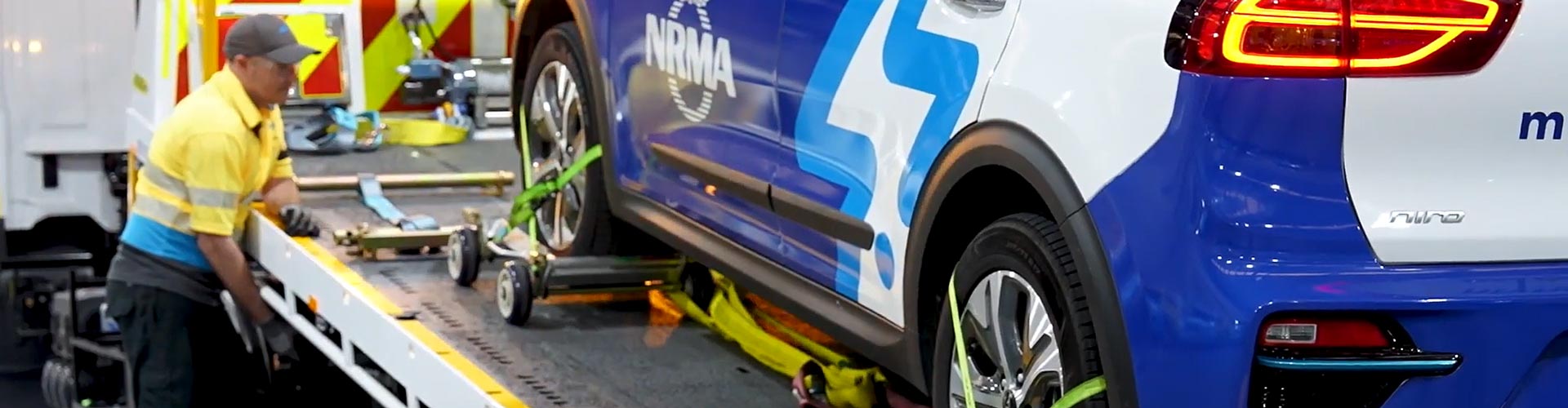 NRMA roadside assist staff winches an EV up on to a tow truck