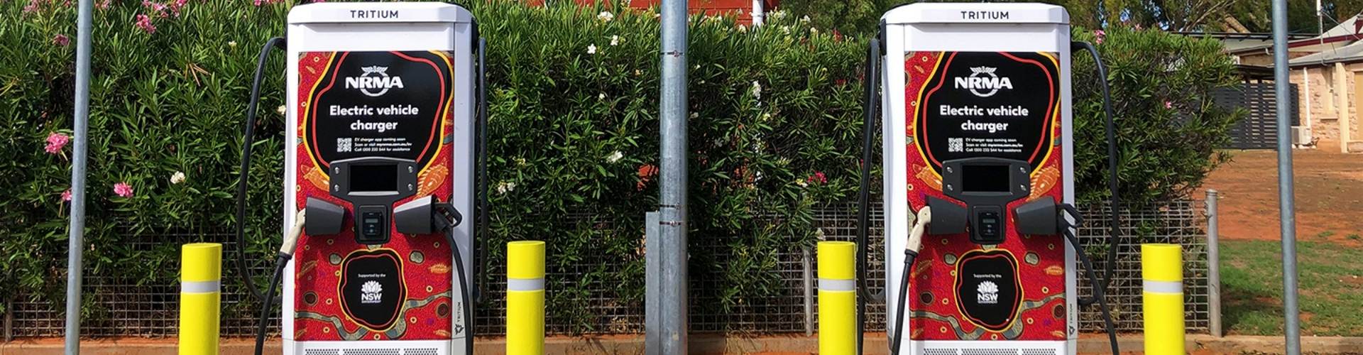 An electric NRMA branded vehicle charger, which has an intricate piece of art on the front by indigenous artist Eddy Harris.