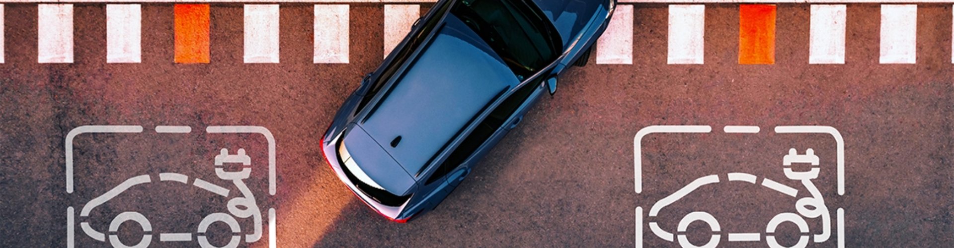 A car pulls into an EV-designated parking spot
