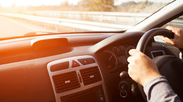 Dashboard and steering wheel on open road