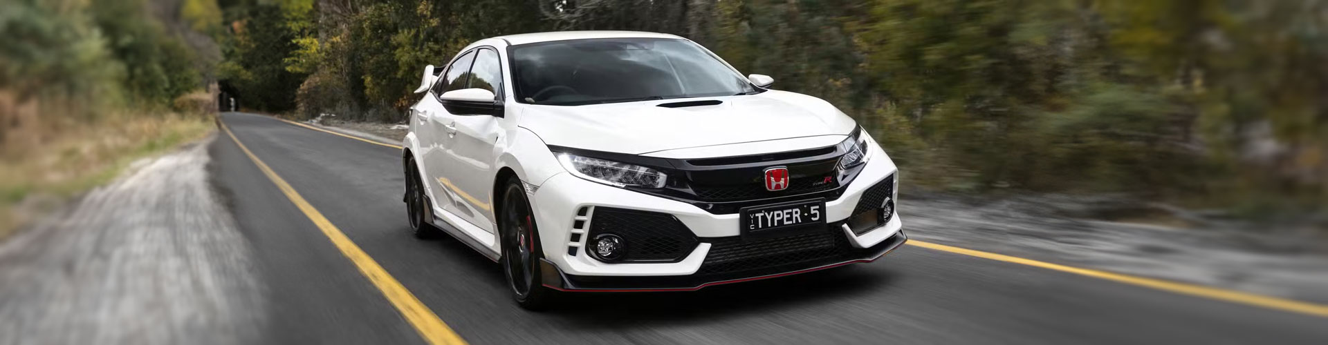 White Honda Type R driving on country road
