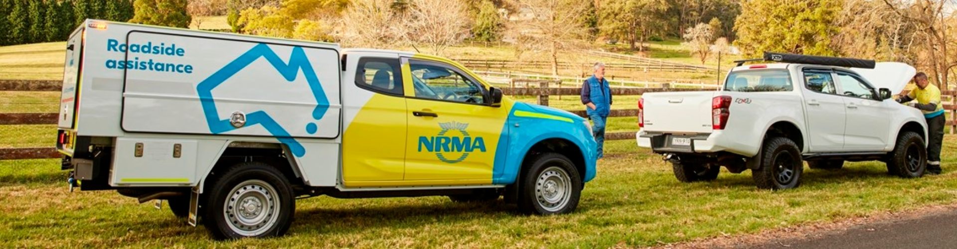 A broken down ute by a country road is attended to by an NRMA patrol