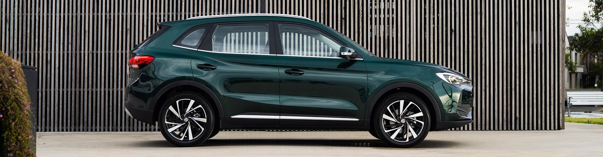 MG ZS hybrid+ parked in from of wooden wall