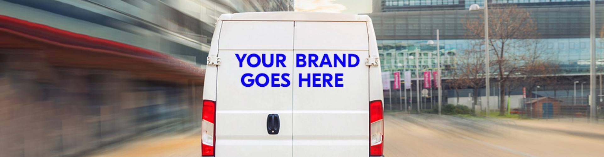 The back of a white van with the words 'Your brand goes here' written across the doors