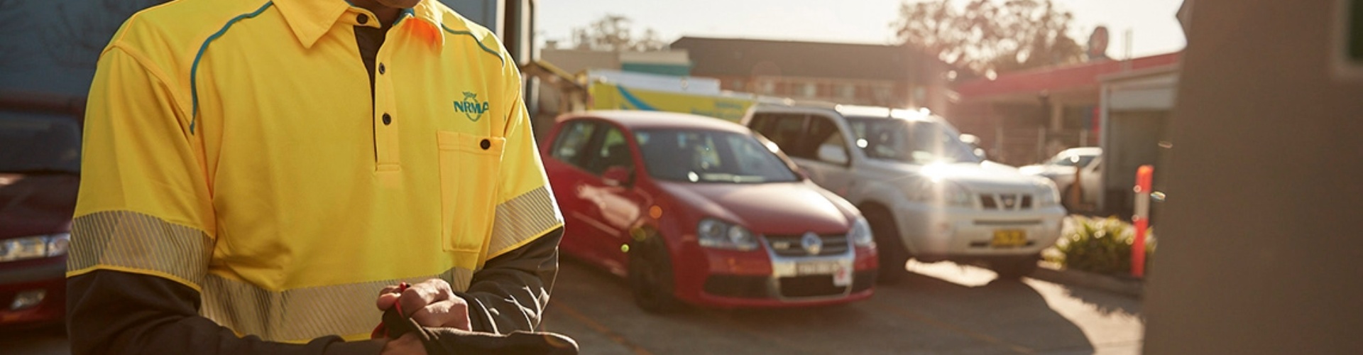 An NRMA patrol person looks under the bonnet of a vehicle