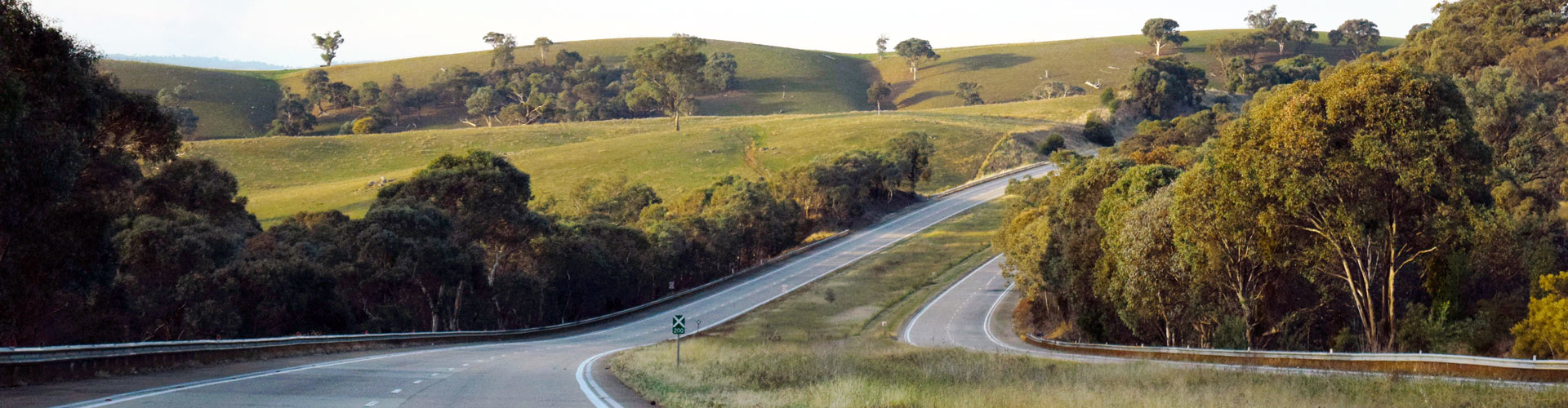 A highway in Australia meandering through rolling hills
