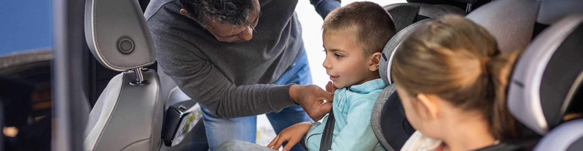 Children being secured into car-seats
