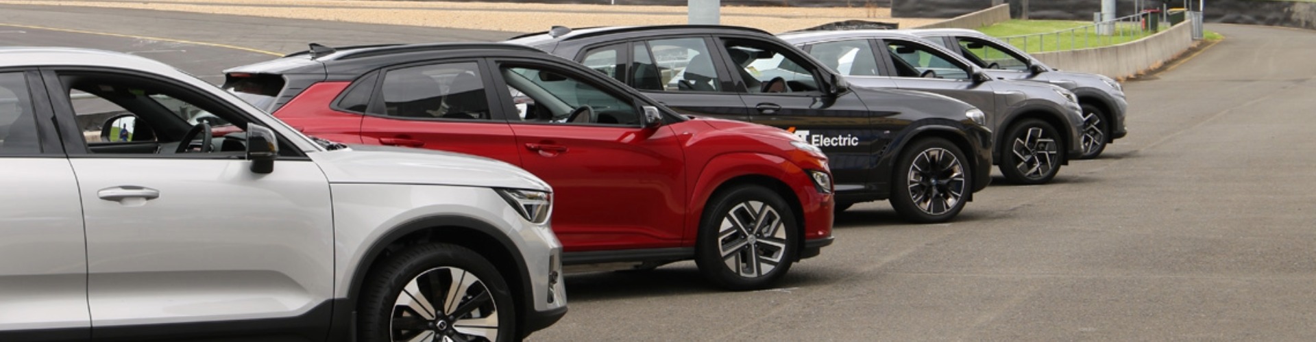 A range of EVs lined up in a carpark
