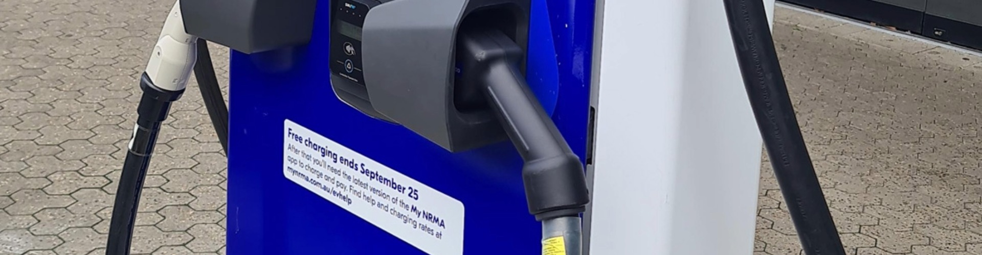 A notice on an NRMA EV charger informing users that free charging will end on September 25 (2023)