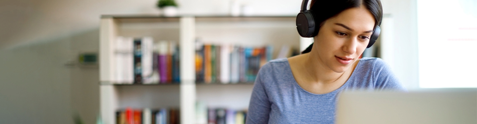 A young person studies with a laptop