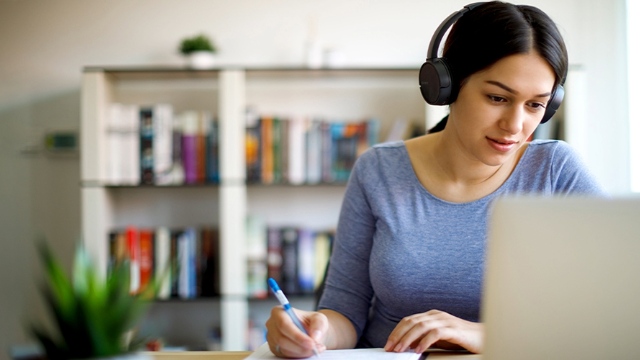 A young person studies with a laptop