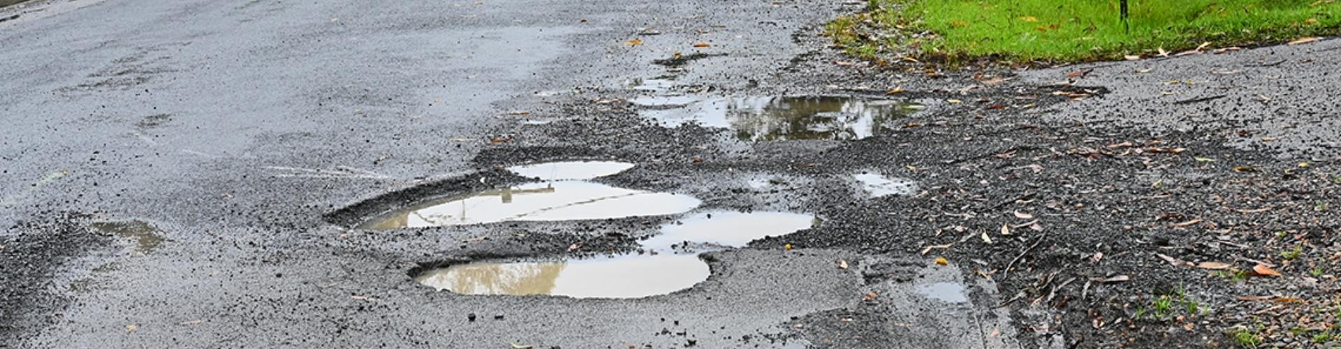 A road in poor condition with potholes