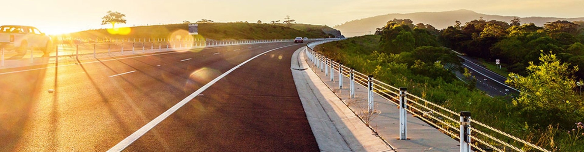 The sun setting on a stretch of country highway