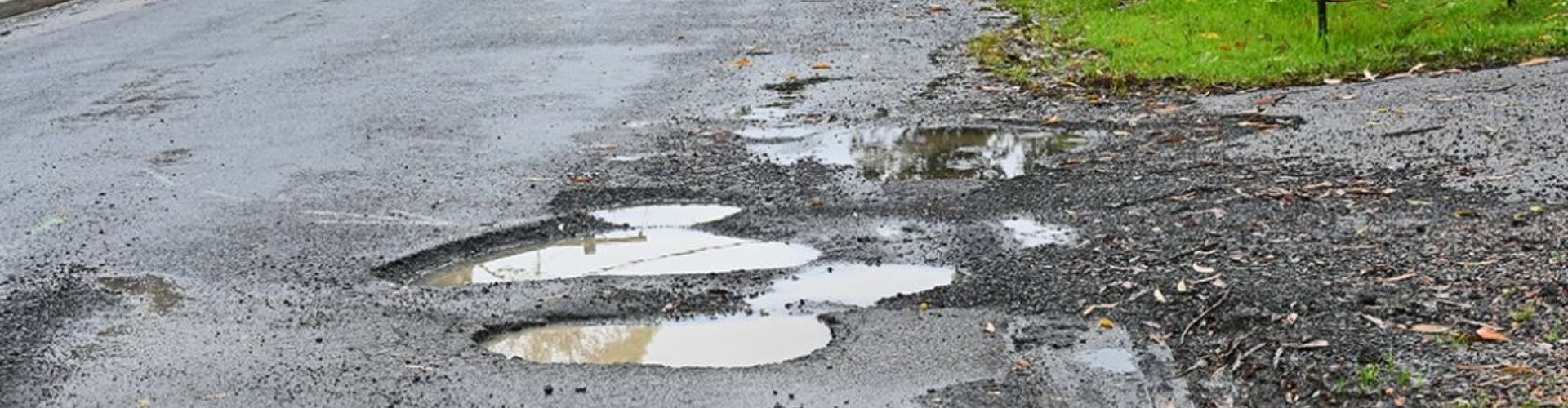 Puddles and potholes in a road surface