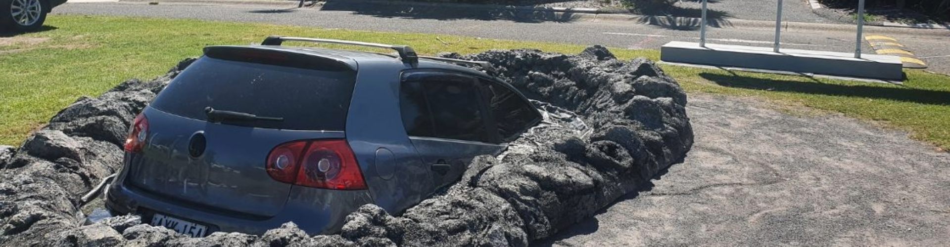 What appears to be a car singing into a pothole