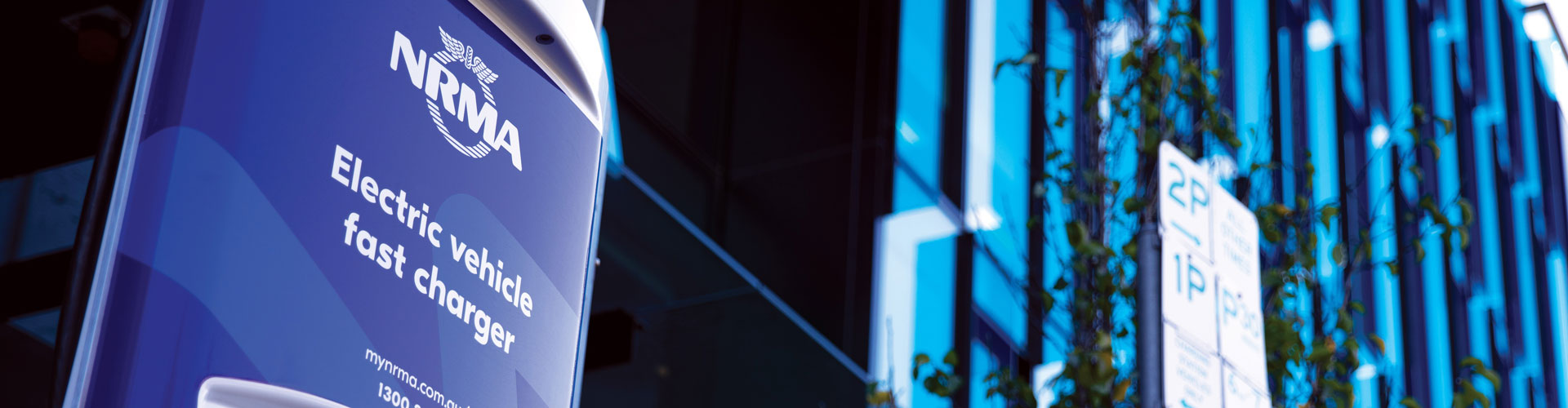 NRMA logo on an EV charger in front of a building