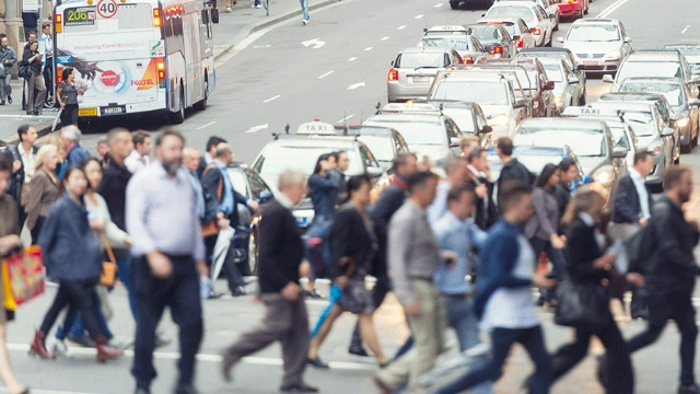 Pedestrians crossing a busy city intersection