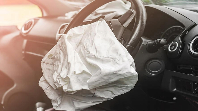 An opened, deflated driver's seat airbag