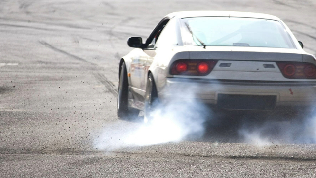 Rear view of a car performing a burn-out