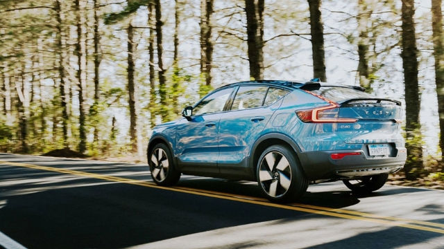 blue electric vehicle driving on a country road