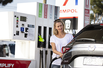 Woman fueling car at Ampol