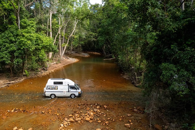 A van crosses a ford on the Bloomfield Track