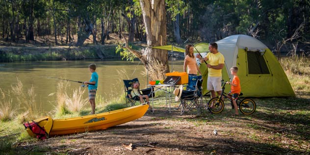 A family camping on the Murray River with a kayak