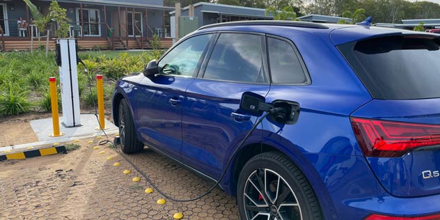 Blue EV plugged into AC charger