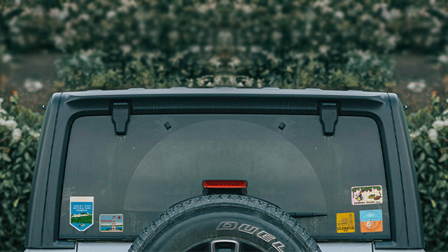 Rear windscreen of car with travel stickers