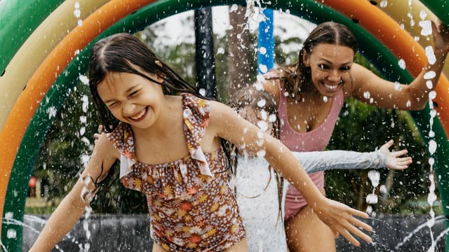 A family playing in the water park at NRMA Ocean Beach Holiday Resort in Umina
