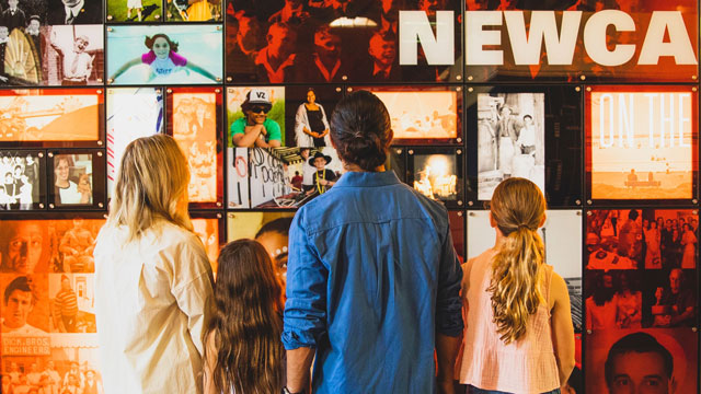 A family stands in front of a wall at Newcastle Gallery