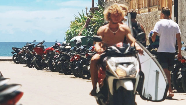 Young man rides moped without helmet