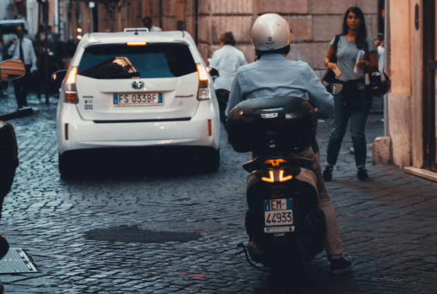 Wearing helmet while riding scooter in Rome