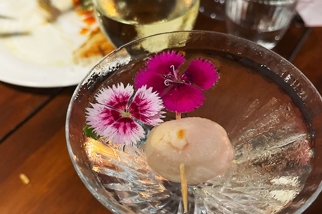 Closeup of a martini with a lychee in it