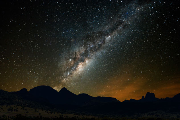 Composite image of Milky Way galaxy behind silhouette of the Warrumbungles National Park