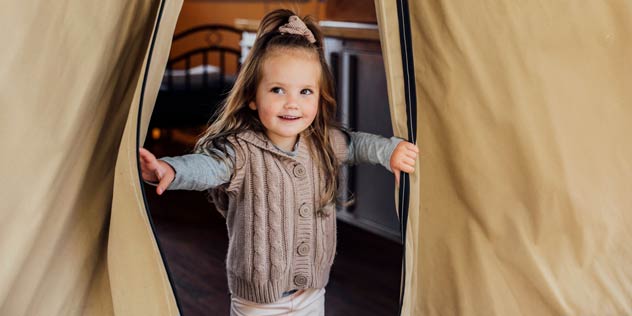 Young girl enjoying her stay in the Sunshine Tent accommodation in BIG4 NRMA South West Rocks