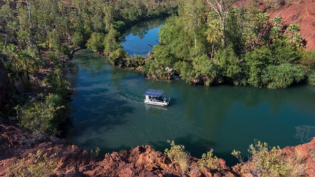 ariel view of solar-powered boat on a river