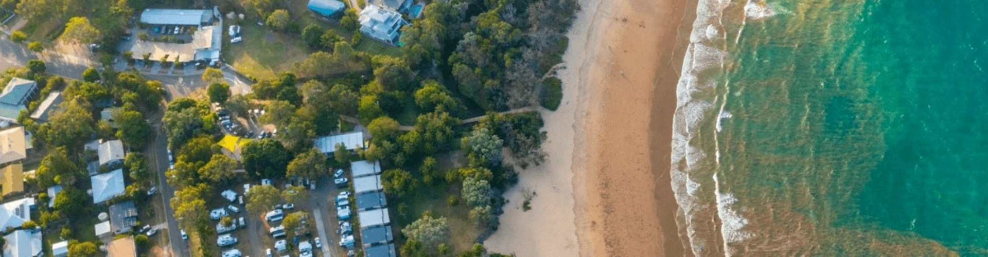 An ariel view of Murramarang resort nestled alongside a beautiful beach.