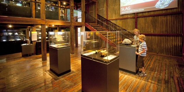 inside the museum two children gaze at a 42kg silver nugget in a glass case