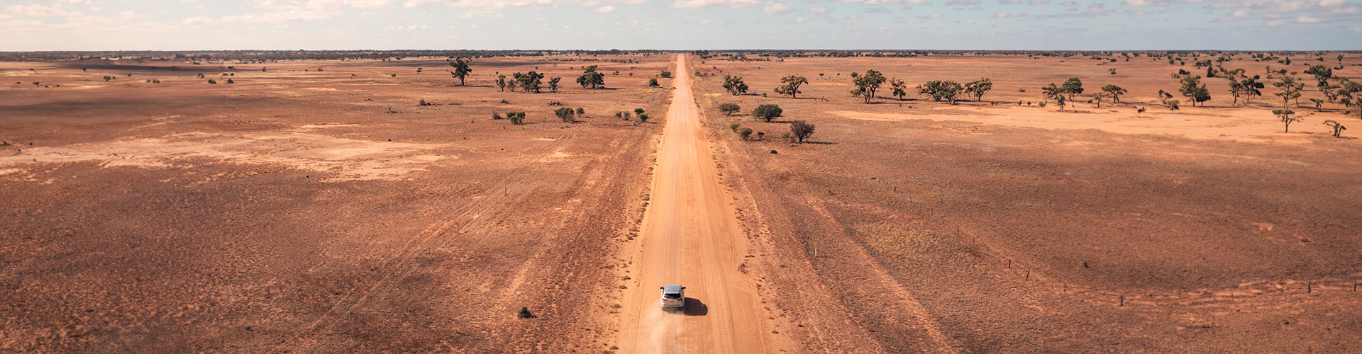 Car driving on dirt road from Broken Hill to Pooncarie NSW