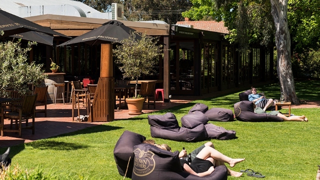people relaxing in outdoor beanbags at Brown Brothers winery Milawa VIC