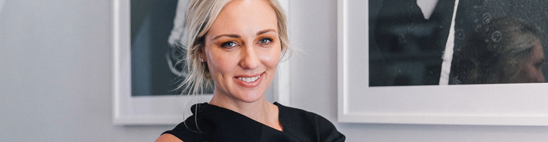 Canna Campbell financial planner canna has blond, tied-back hair and has a warm smile. She wears an asymmetrical black top and her head and shoulders are visible