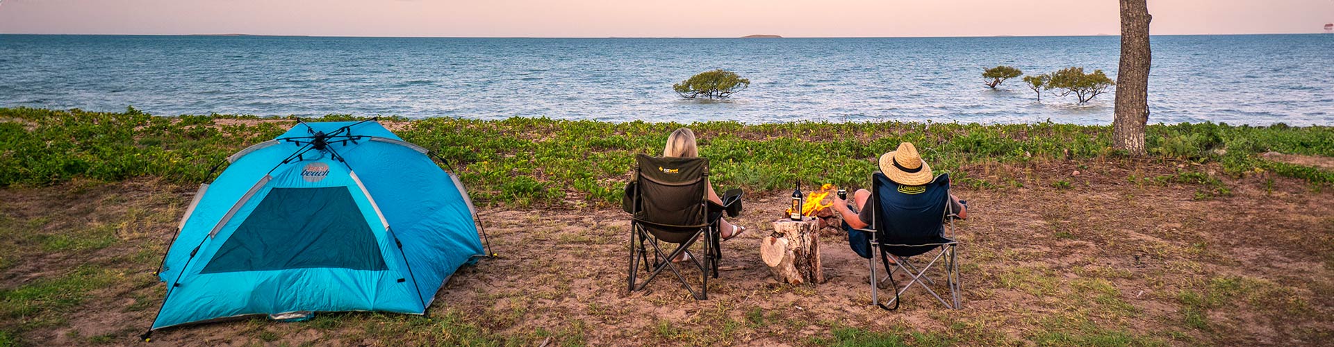 A couple camps by a Queensland beach