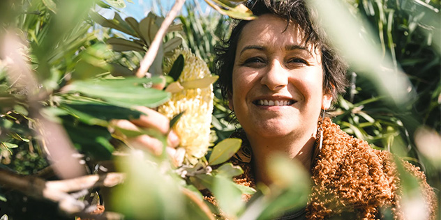 A woman behind leaves